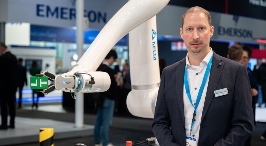 Michael Mayer Rosa, Senior Director of Delta Electronics Europe, Middle East, and Africa (EMEA), with the company's new product "Cobot"